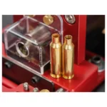 Hornady High Speed 3-in-1 Power Case Trimmer, close-up with red housing and two brass cases