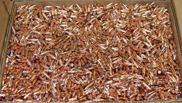 Hornady Traditional Rifle Bullets, top view of loose copper-colored bullets in a cardboard box