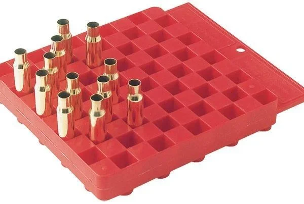 Hornady Universal Reloading Block, red block in top angled view with several cartridge cases