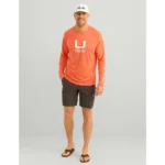 Huk Icon Crew Long Sleeve Shirt in fresh salmon, front view on model with white chest logo