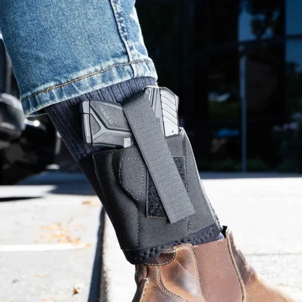 Galco Cop Ankle Band black right-hand ankle holster worn over jeans with handgun visible