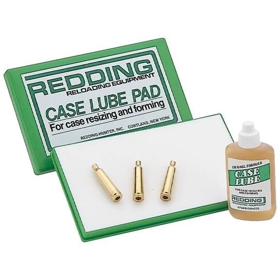 Redding Case Lube Kit with green pad case, white lubricating pad, bottle and three brass cases