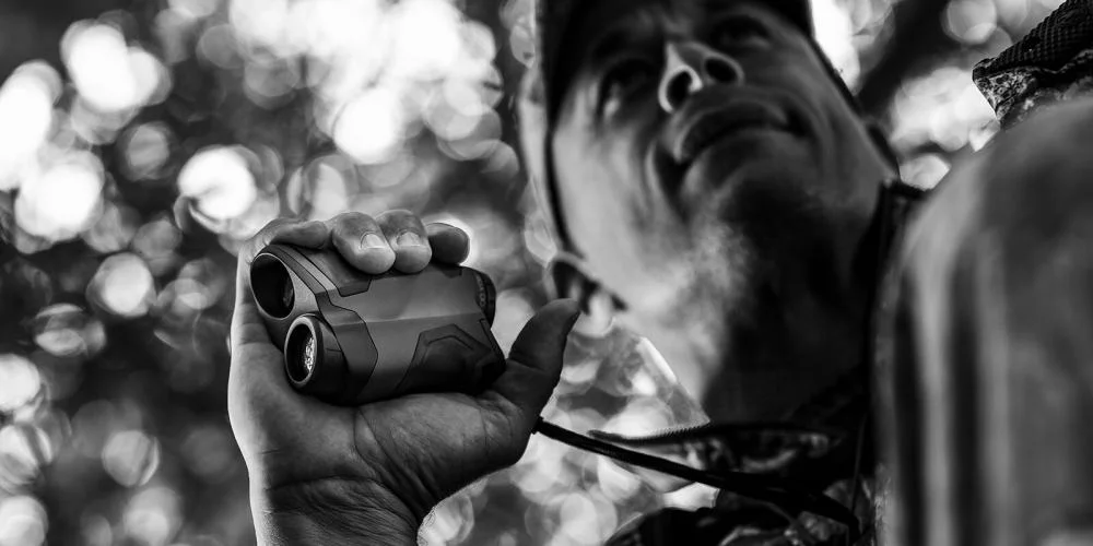 primary-34568 Gsm Halo XR700 6x Rangerfinder black handheld unit in use, black-and-white side view