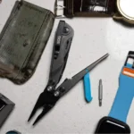 SOG Flash MT Multi-Tool, open black pliers with cyan handle accent among pocket tools