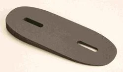 KICK-EEZ Pitch Spacer, dark oval spacer in angled top view with two elongated mounting slots