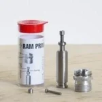 Lee Ram Prime, metal priming components beside a white and red storage tube