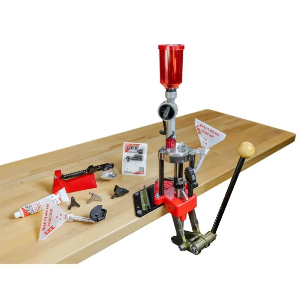 Lee Classic Turret Press Kit, red press mounted on a wood bench with tools and accessories