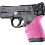 Hogue HandAll Beavertail Grip Sleeve in pink, installed on the grip of a black pistol