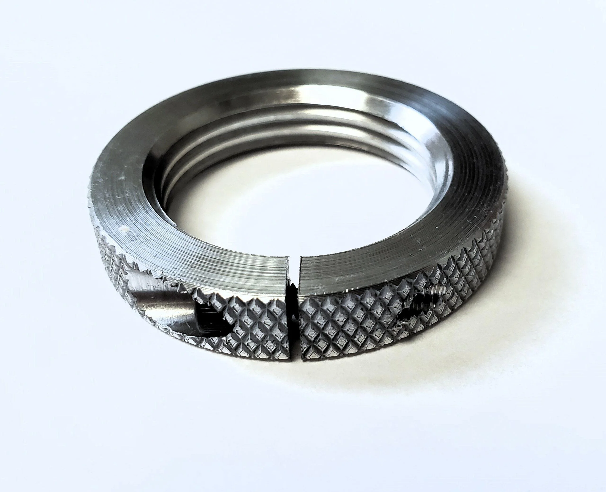 primary-41000 Forster 1-1/4 Crossbolt Die Lock Ring silver top view with threads and knurled edge