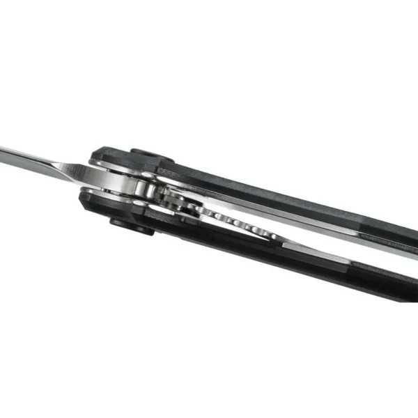 CRKT P.S.D. folding knife, black carbon-fiber handle and partially visible silver blade, top view