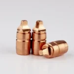 Lehigh Xtreme Cavitator copper-colored rifle bullets, three upright and one on its side
