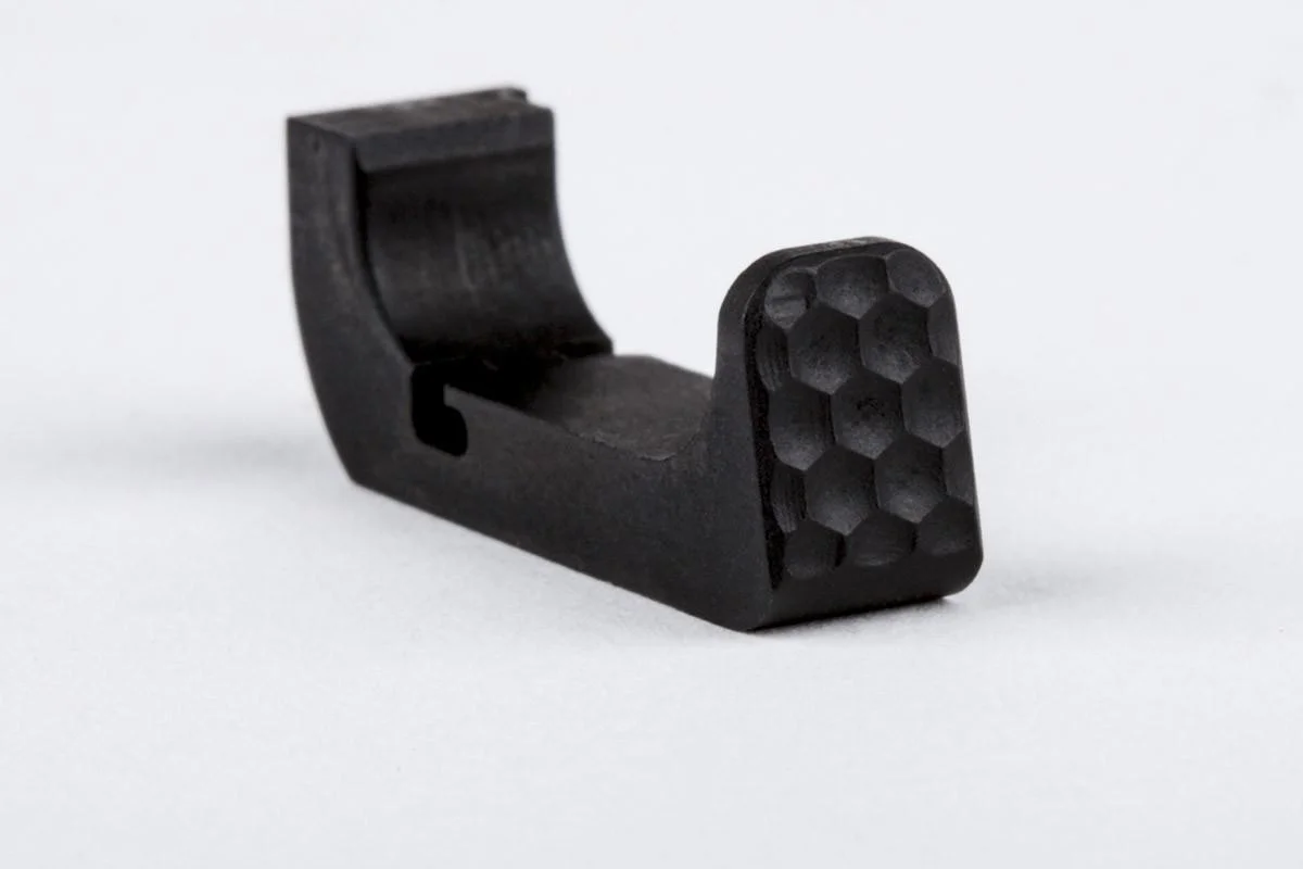 primary-42999 ZEV Mag Release 4th Gen Small, angled view of black release with textured pad