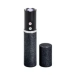 Sabre Fashionable Stun Gun black, upright with glittery body and cap removed beside it
