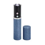Sabre Fashionable Stun Gun blue, upright with glittery body and cap removed beside it