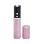Sabre Fashionable Stun Gun pink, upright with glittery body and cap removed beside it