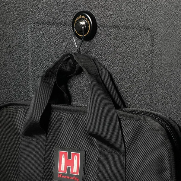 SnapSafe Magnetic Hooks, round black hook mounted on a textured surface and holding a bag