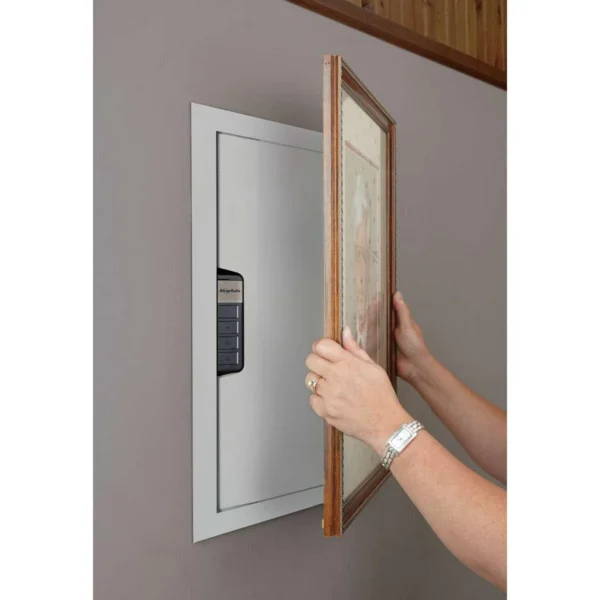 SnapSafe In-Wall Safes Electronic In Wall, white safe installed behind an open framed panel