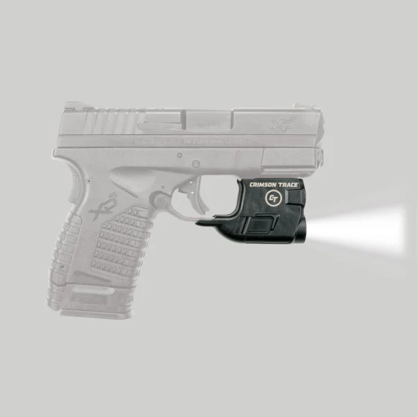 Crimson Trace LightGuard Springfield XD-5, black unit mounted under pistol with white light on