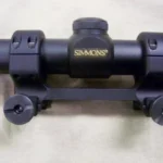 DNZ Freedom Reaper 1-Piece Picatinny Scope Mount, matte black front view holding a scope