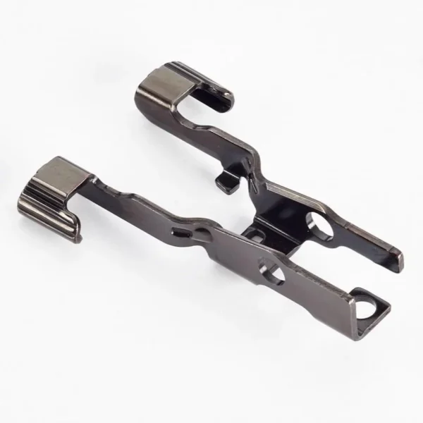 Wilson Extended Slide Release WCP320, angled view of two black metal release components