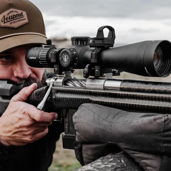 Leupold Mark 4HD Rifle Scope, black right-side view mounted on a rifle as a shooter aims