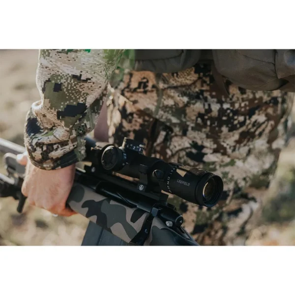 Leupold VX-5HD Gen 2 Rifle Scope, right-side view mounted on a rifle held by a camouflaged person