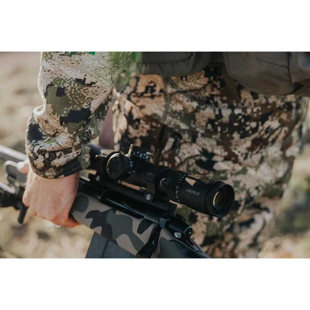 primary-48321 Leupold VX-5HD Gen 2 Rifle Scope, right-side view mounted on a rifle held by a camouflaged person