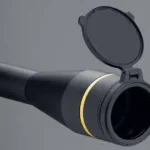 Leupold Alumina Flip Back Lens Cover, black and open on the front of a scope
