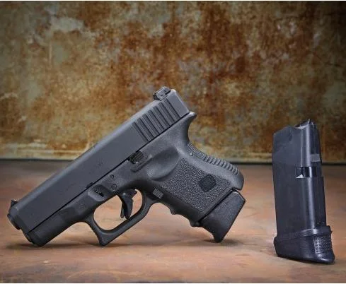 Pachmayr/Tacstar Division Grip Extender XL Glock 26273339, black extender beside handgun