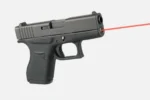 LaserMax Glock Guide Rod Laser 43, red laser beam projecting from the front of a black handgun