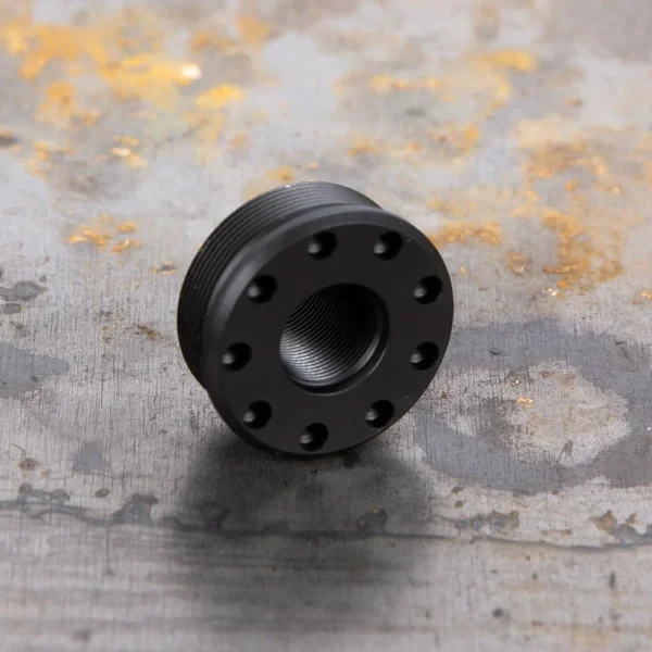SilencerCo SCO ALPHA DIRECT THREAD, black angled front view with threaded center and circular ports