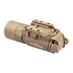 SUREFIRE X300U-A, tan weapon light in angled side view with mounting controls and round bezel