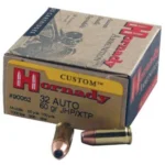 Hornady HRNDY, tan ammunition box with two brass cartridges and copper-colored bullet tips