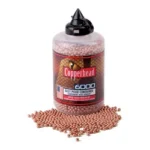 Crosman Copperhead BBs bottle with copper-colored BBs spilled beside it