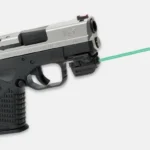 LaserMax LMS-Micro Rail Mounted Laser, black unit mounted beneath a pistol with green beam visible