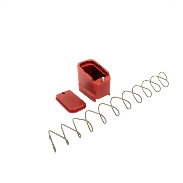 Shield Arms Handgun Magazine Extension red base components with silver spring, angled view