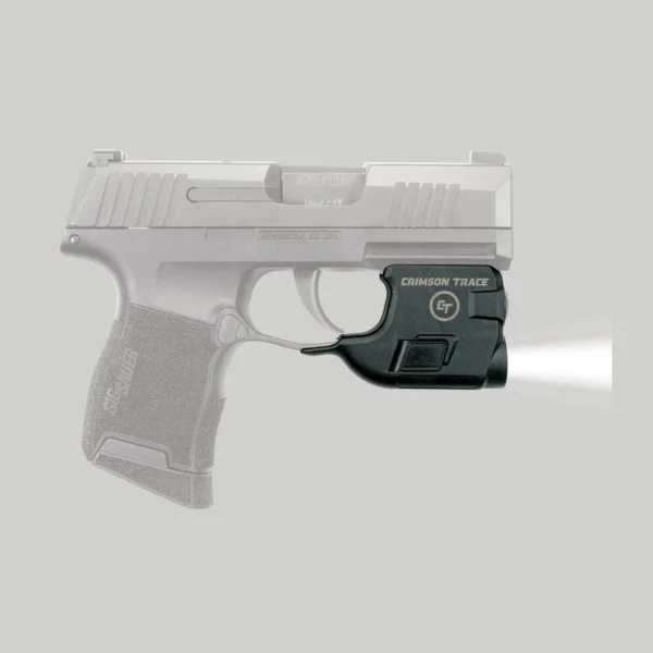 Crimson Trace Lightguard, black light mounted under a translucent SIG P365 with beam illuminated