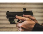 Viridian RFX15 black reflex sight mounted on a handgun, right-side view with visible green dot