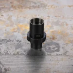 SilencerCo SCO ECHO CHOKE KSG STYLE BLK, black threaded choke upright on a mottled surface