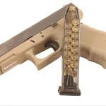 Elite Tactical Systems Glock 17 Magazine, clear magazine beside tan pistol in left-side view