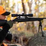 Burris Veracity Rifle Scope, right-side view mounted on a black rifle outdoors with shooter