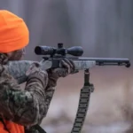 Bushnell Prime Rifle Scope black right-side view mounted on a camouflage rifle in use