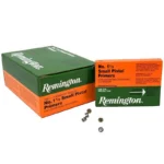 Remington Centerfire Primers, green and orange boxes with several loose primers, front view