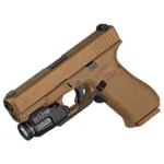 Streamlight TLR-7 Glock Contour Remote, black weapon light mounted beneath a tan handgun