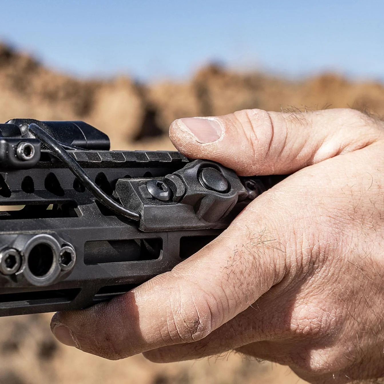 surefire-compact-remote-switch-primary SUREFIRE Compact Switch MLOK black switch mounted on a firearm, hand pressing button